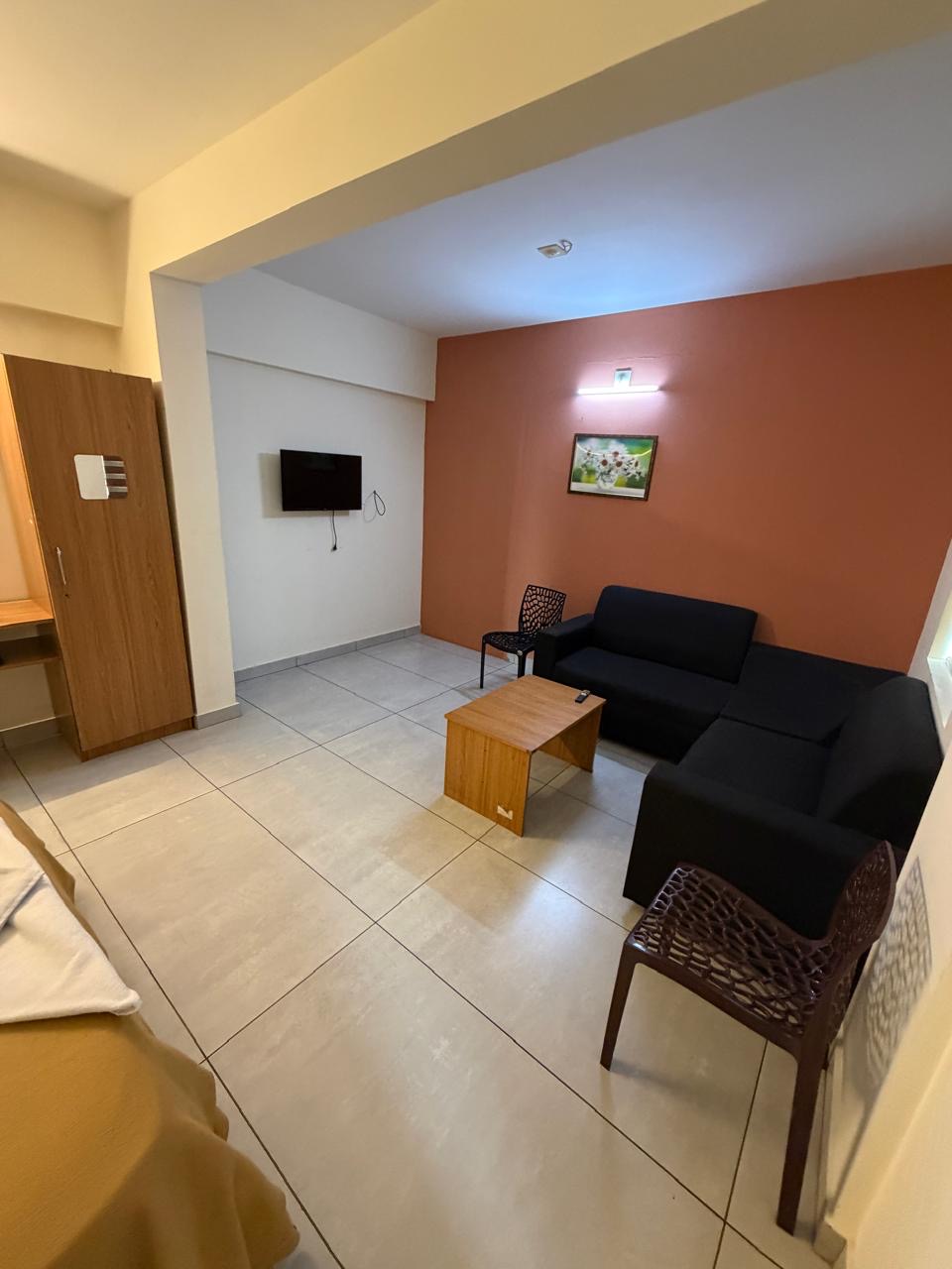 Spacious suite living area at Regal Suites near KIMS Hospital Trivandrum